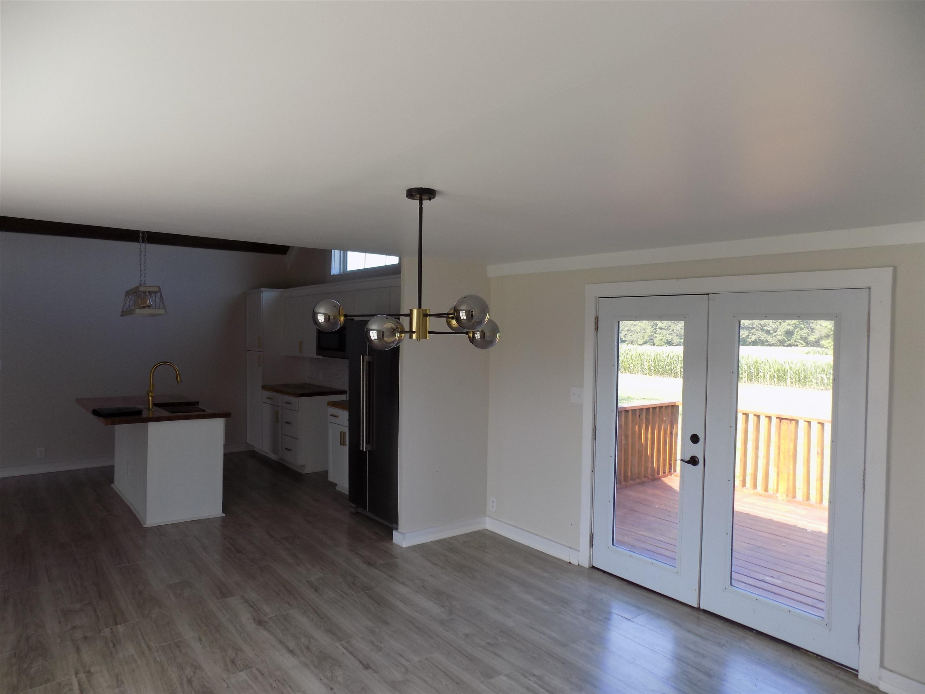 821 Greys Mill Road Louisburg, NC 27549 - Photo 15 of 33 wooden floor in an empty room with a window