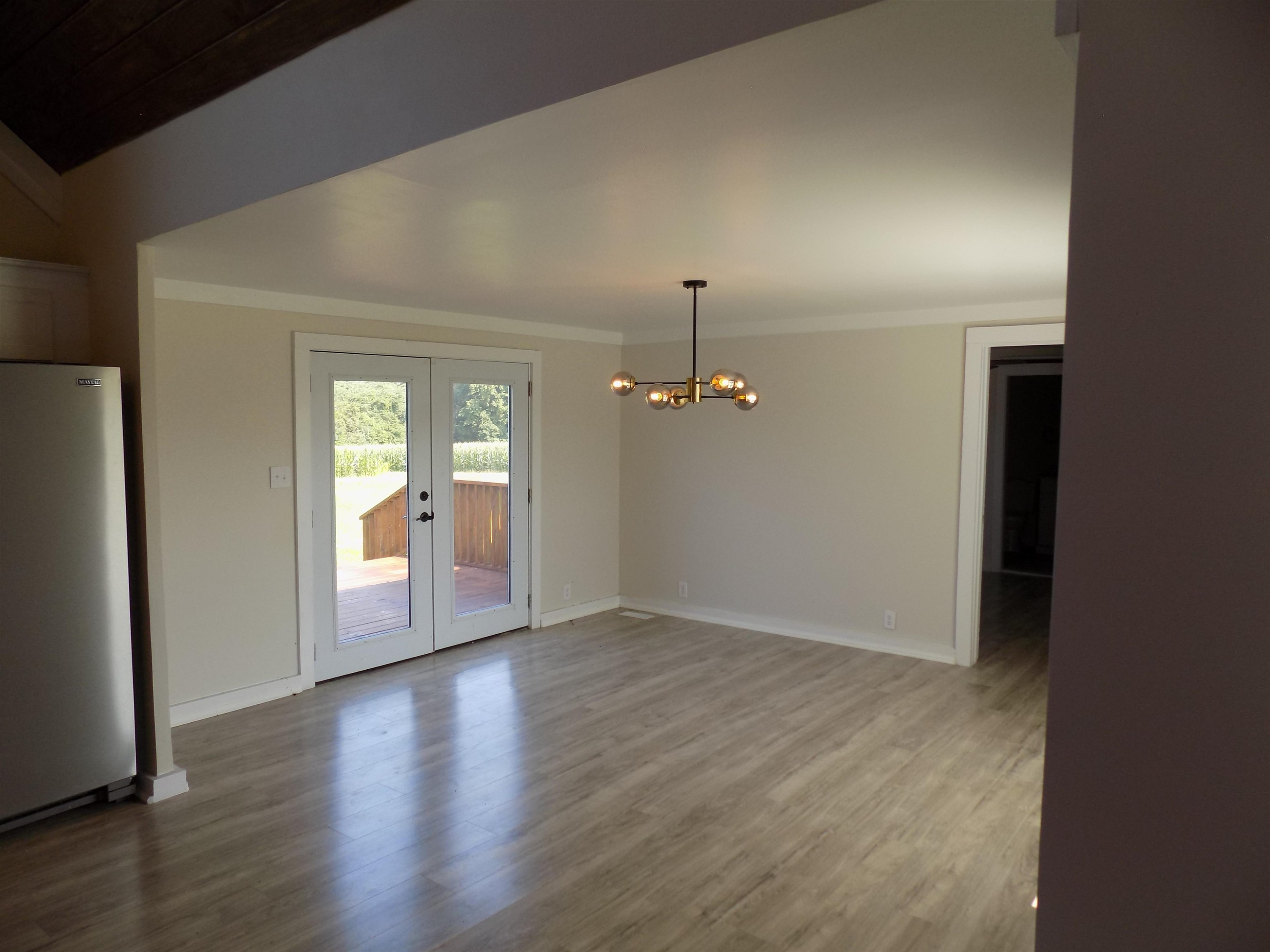 821 Greys Mill Road Louisburg, NC 27549 - Photo 16 of 33 an empty room with wooden floor and mirror