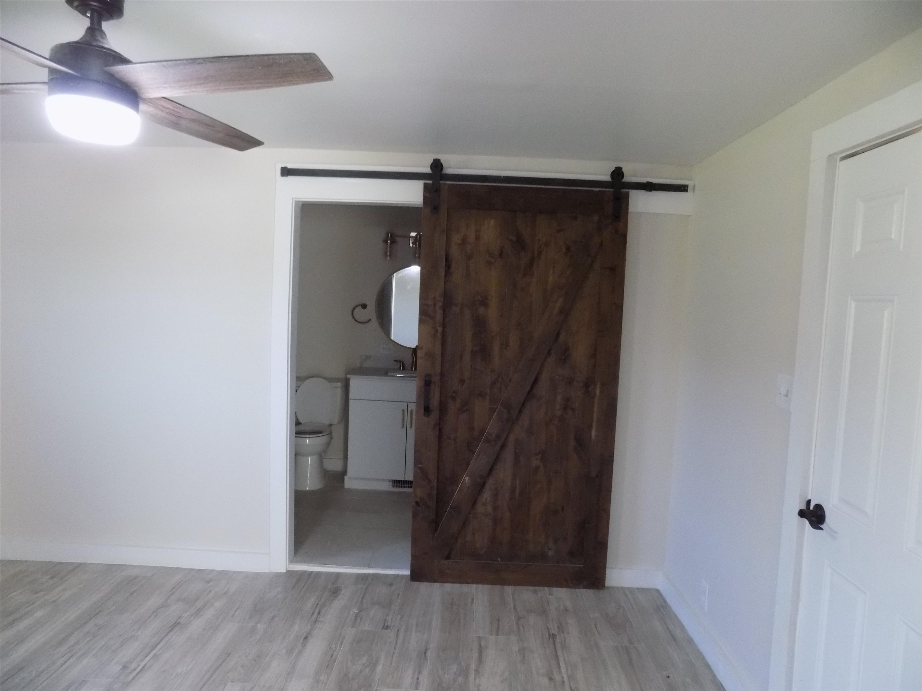 821 Greys Mill Road Louisburg, NC 27549 - Photo 18 of 33 a view of walk in closet with wooden floor