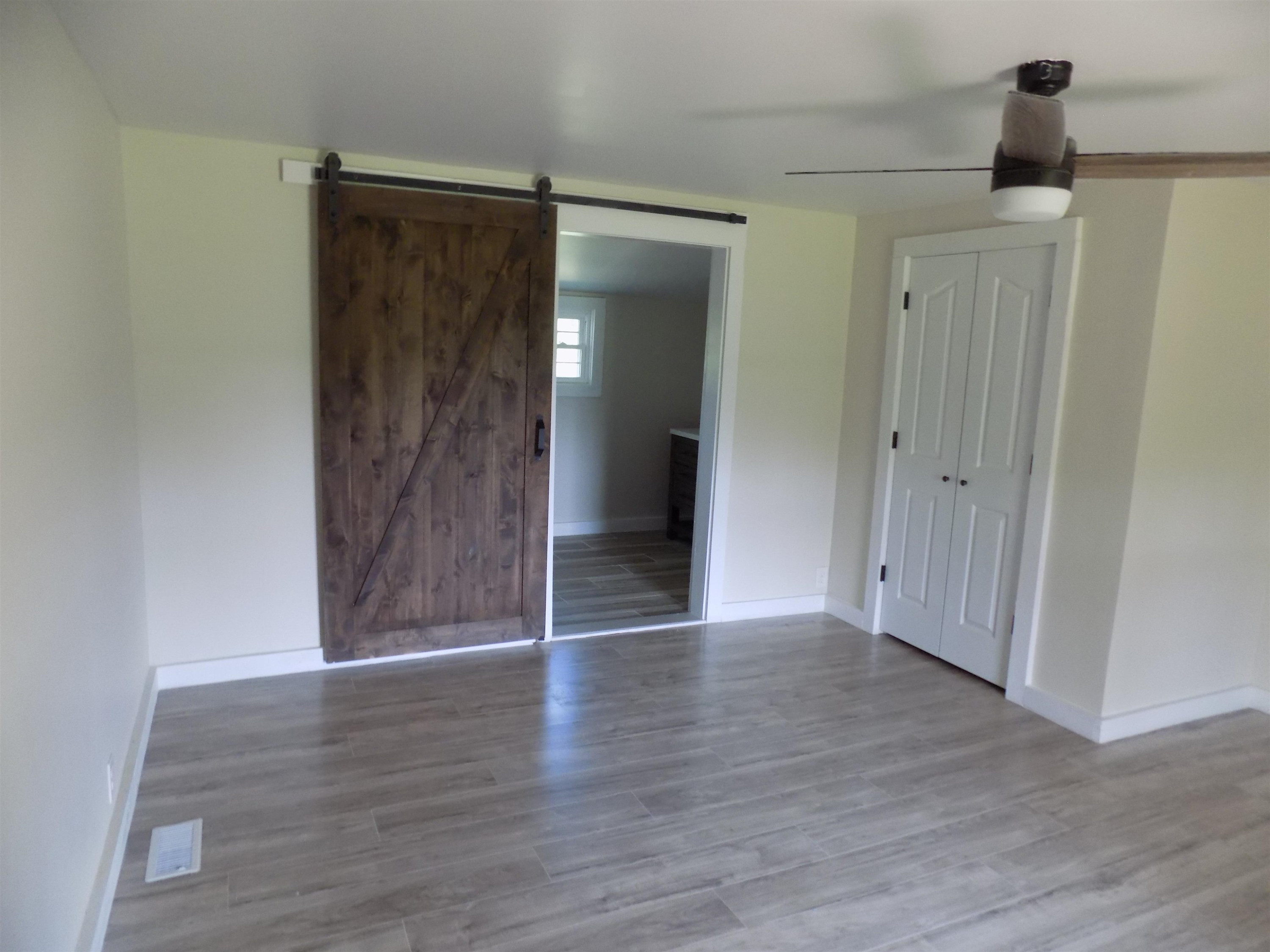 821 Greys Mill Road Louisburg, NC 27549 - Photo 23 of 33 a view of an empty room with wooden floor and closet