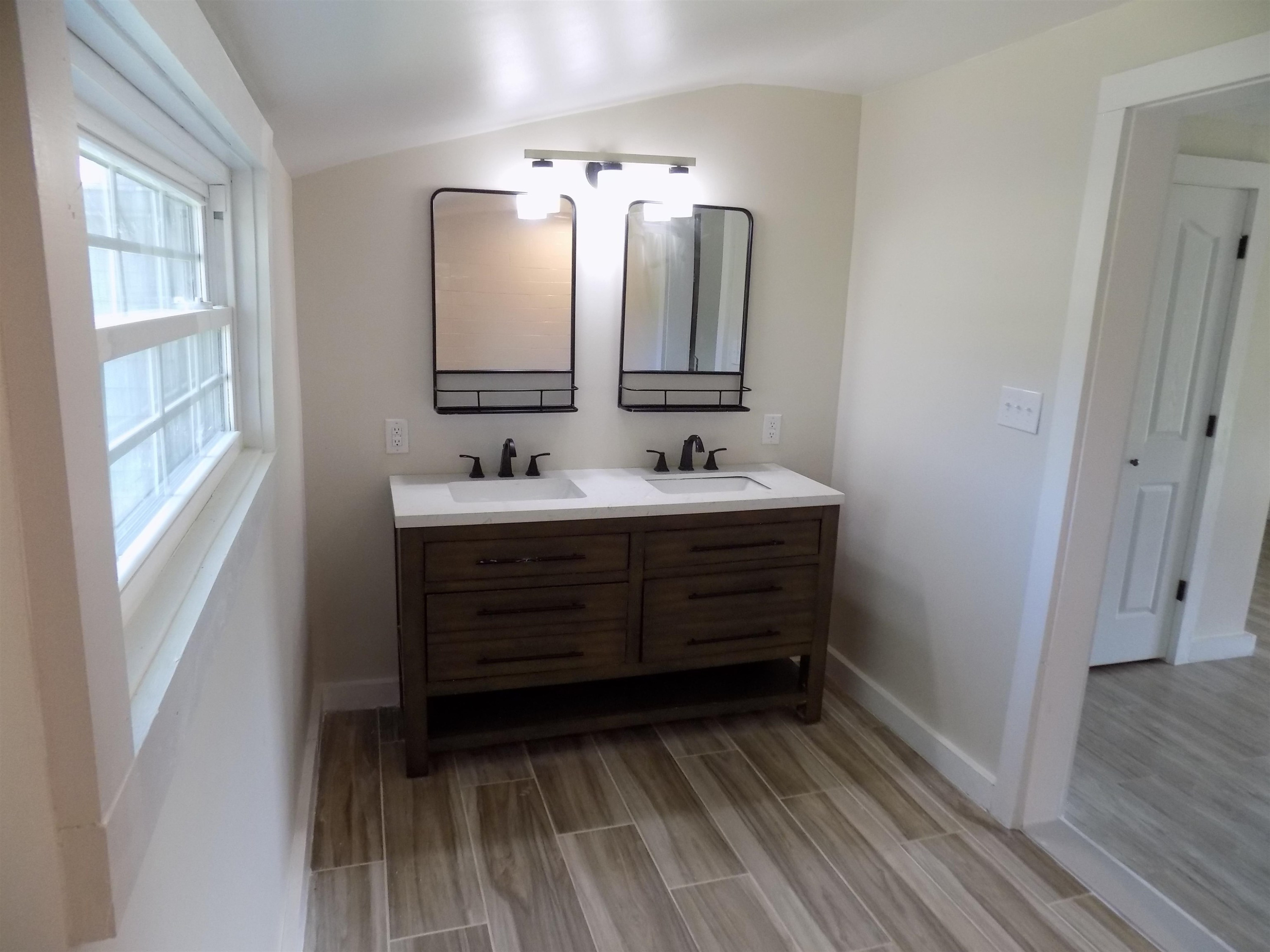 821 Greys Mill Road Louisburg, NC 27549 - Photo 25 of 33 a bathroom with a double vanity sink and mirror