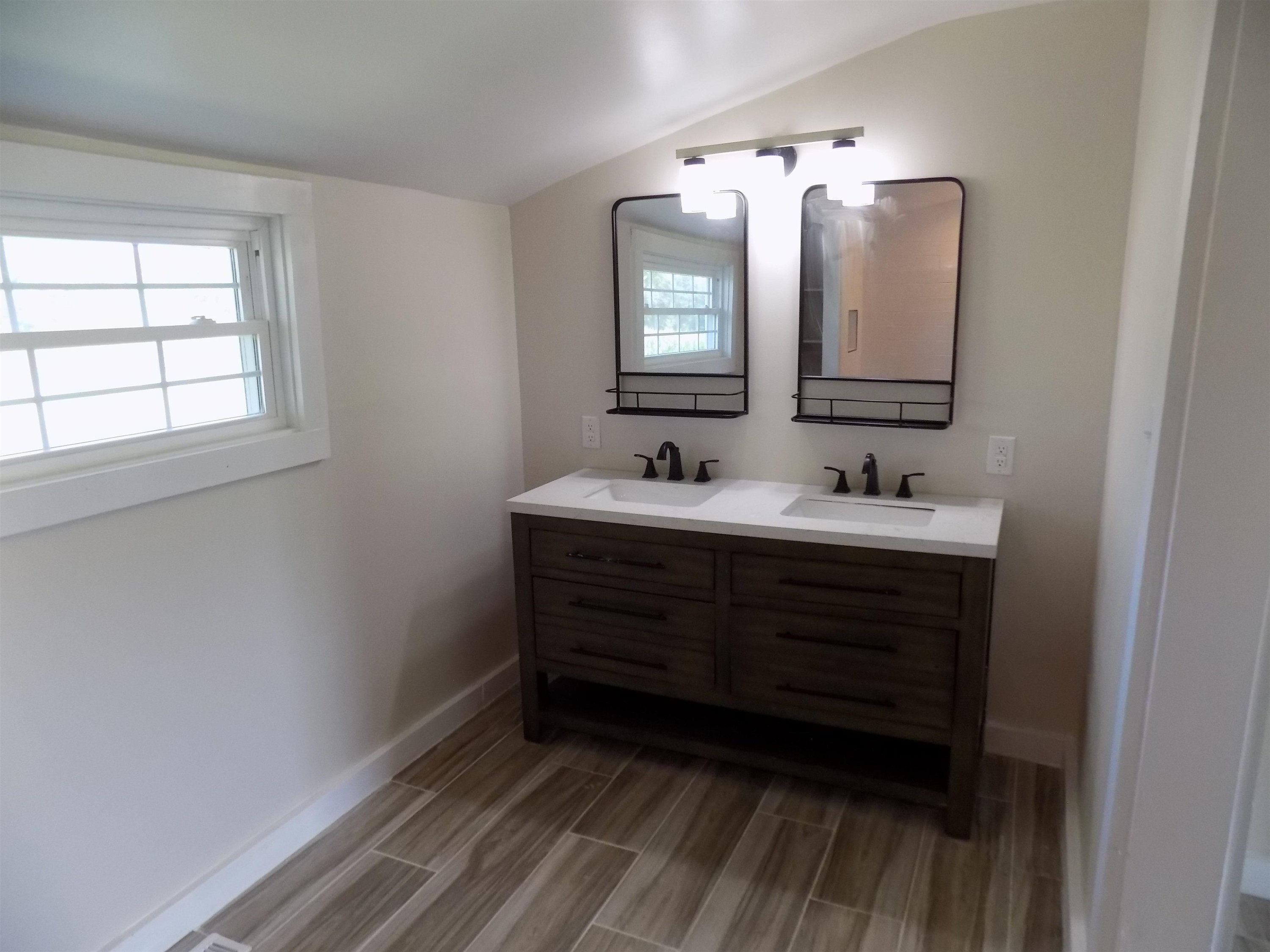 821 Greys Mill Road Louisburg, NC 27549 - Photo 26 of 33 a bathroom with a sink vanity and mirror