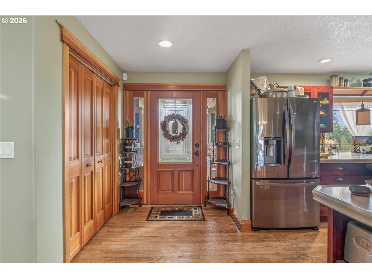 26875 Northwest Bacona Road Buxton, OR 97109 - Photo 18 of 43 a kitchen with stainless steel appliances granite countertop a refrigerator and a stove