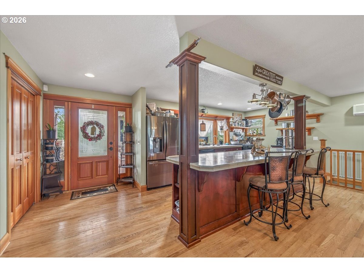 26875 Northwest Bacona Road Buxton, OR 97109 - Photo 19 of 43 a view of a dining room with furniture window and wooden floor