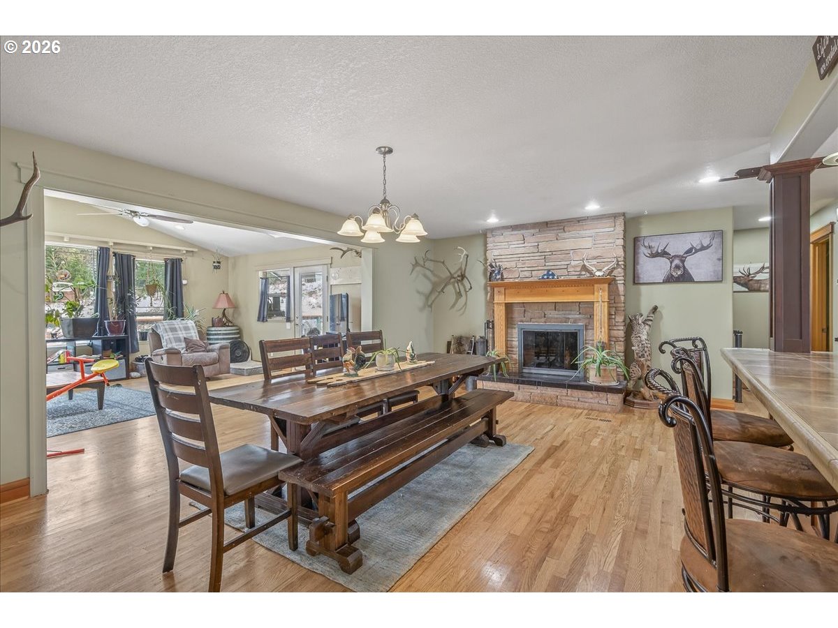 26875 Northwest Bacona Road Buxton, OR 97109 - Photo 25 of 43 a living room with furniture a fireplace and a chandelier