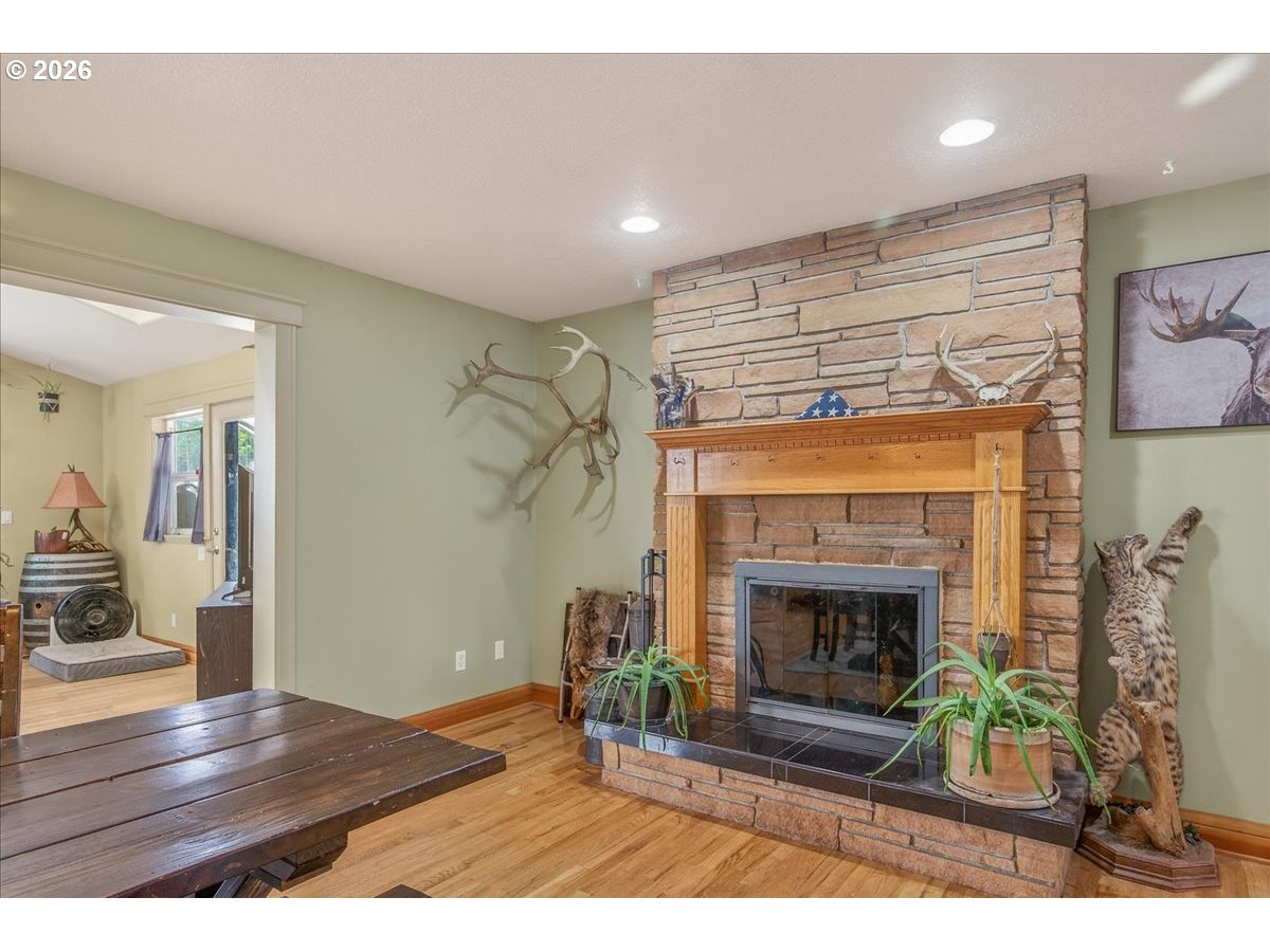 26875 Northwest Bacona Road Buxton, OR 97109 - Photo 26 of 43 a living room with furniture and a fireplace