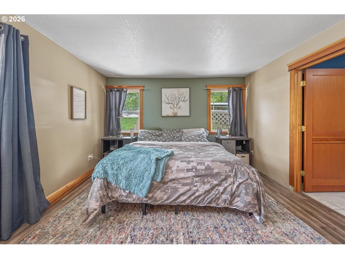 26875 Northwest Bacona Road Buxton, OR 97109 - Photo 33 of 43 a bed sitting in a spacious bedroom next to a window