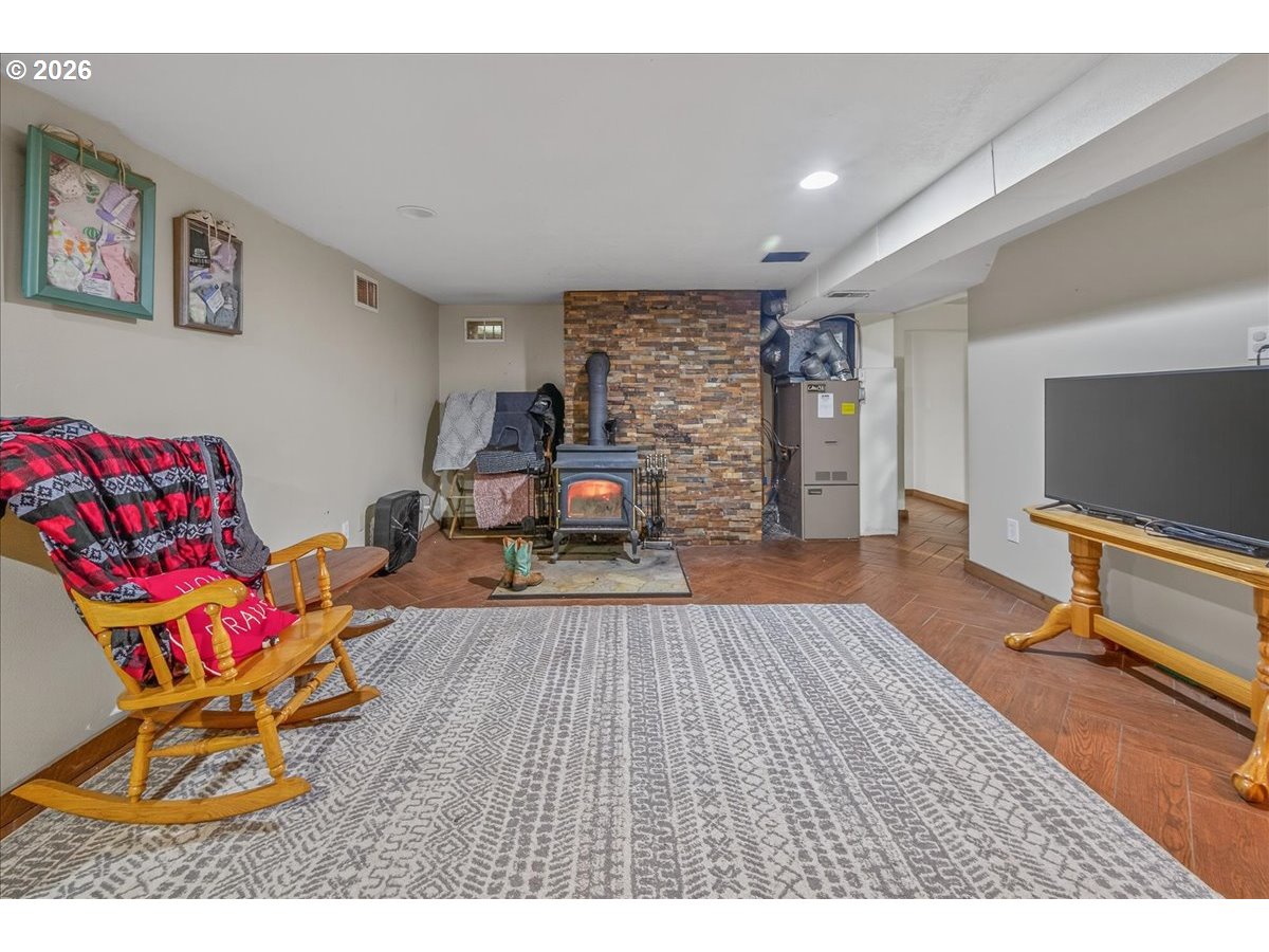 26875 Northwest Bacona Road Buxton, OR 97109 - Photo 39 of 43 a living room with furniture flat screen tv and gym equipment
