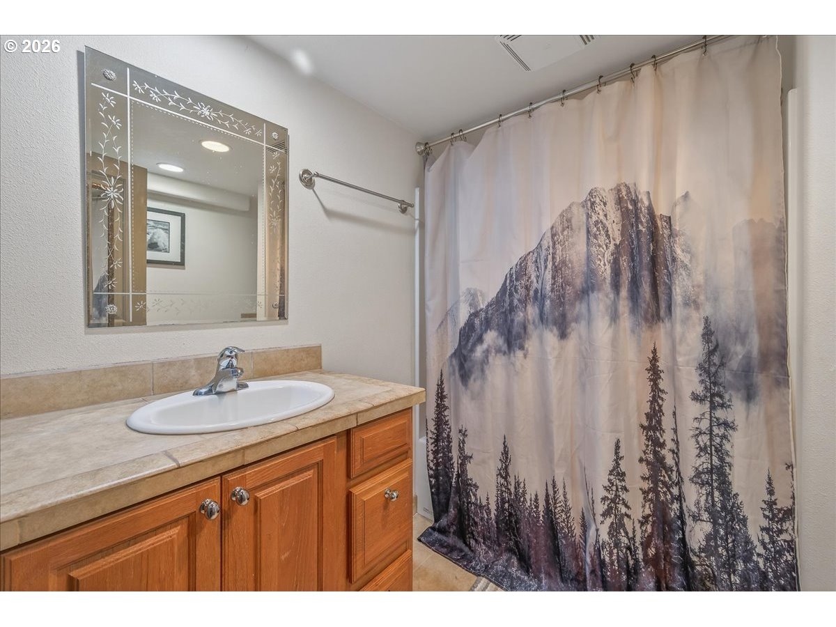 26875 Northwest Bacona Road Buxton, OR 97109 - Photo 41 of 43 a bathroom with a sink vanity and a mirror