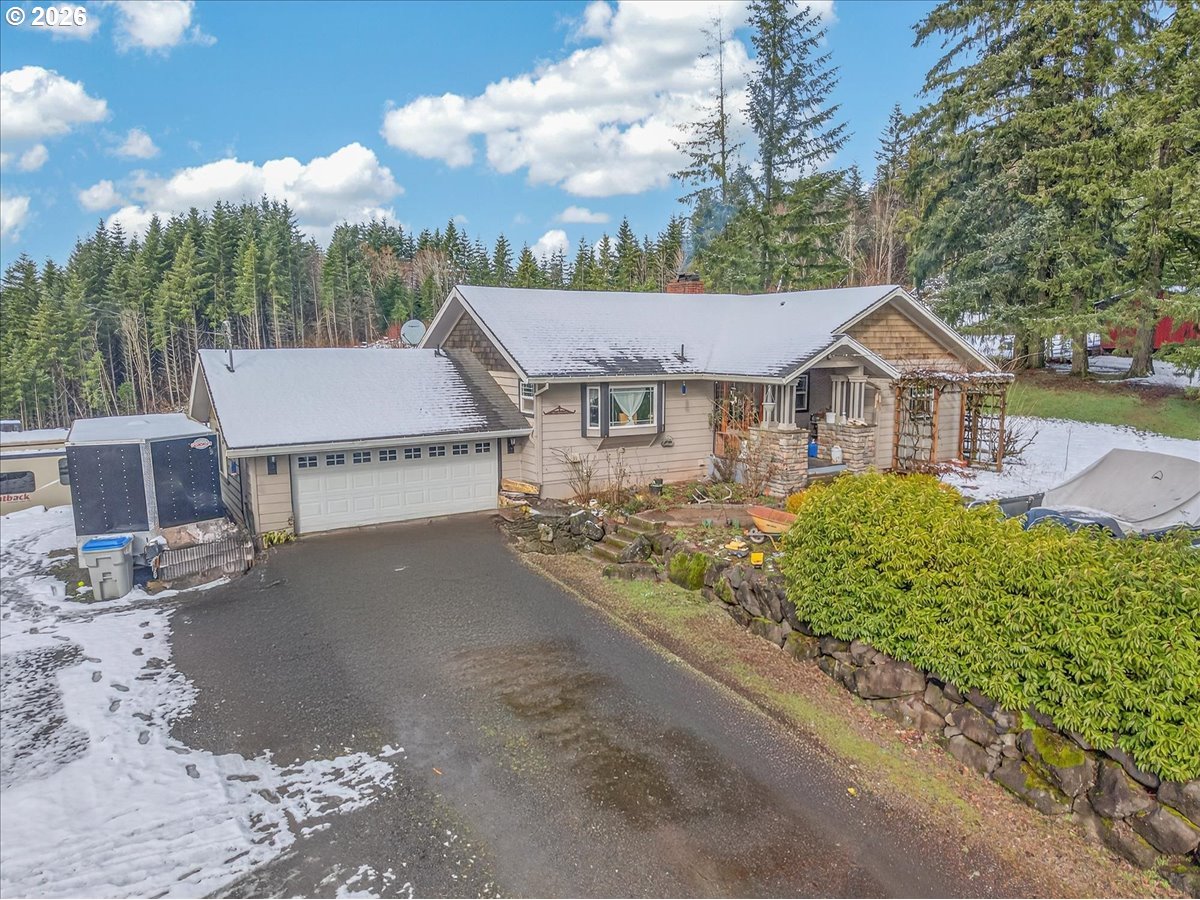 26875 Northwest Bacona Road Buxton, OR 97109 - Photo 10 of 43 a front view of a house with a garden and tree