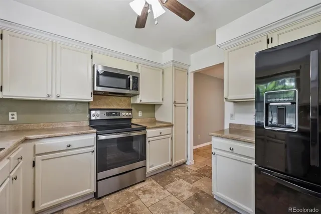 a kitchen with stainless steel appliances granite countertop a sink and a stove