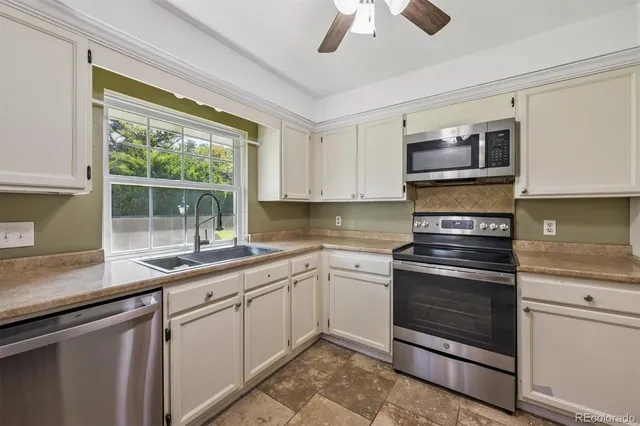 a kitchen with a sink stove and cabinets