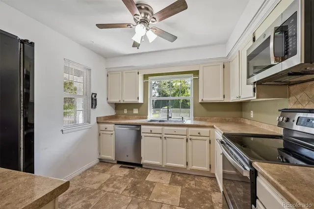 a bathroom with a granite countertop sink a toilet and a mirror