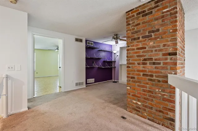 an empty room with windows and closet