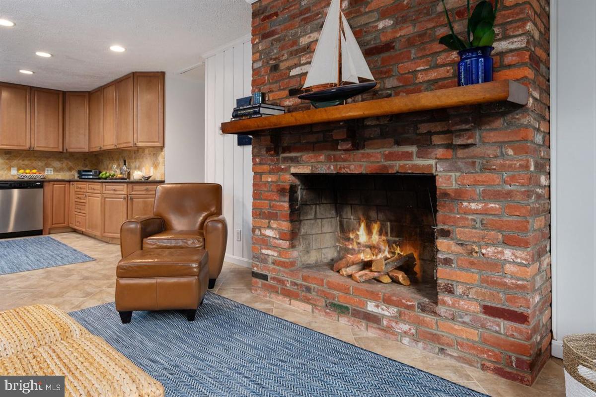 335 Tennessee Road Stevensville, MD 21666 - Photo 14 of 34 Brick Hearth Fireplace Sharing Warm Ambiance