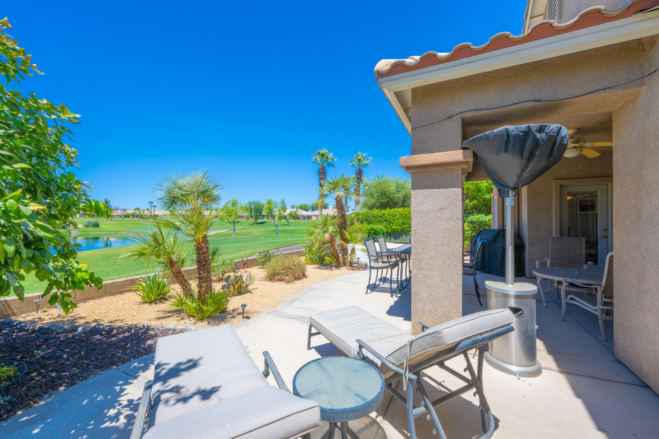 a view of a chairs and table in patio