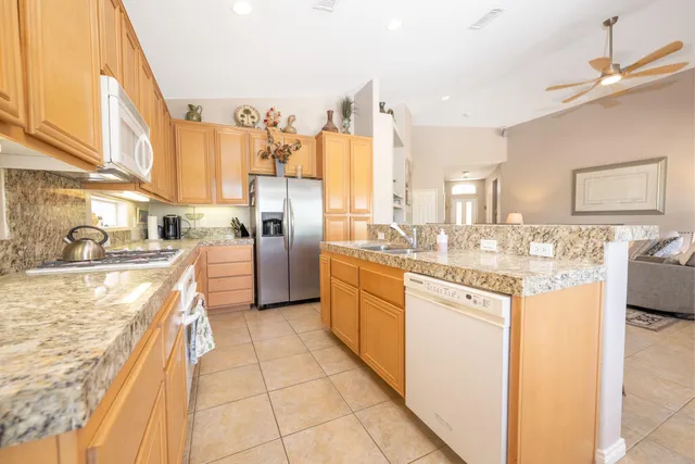 a kitchen with stainless steel appliances granite countertop a sink and cabinets