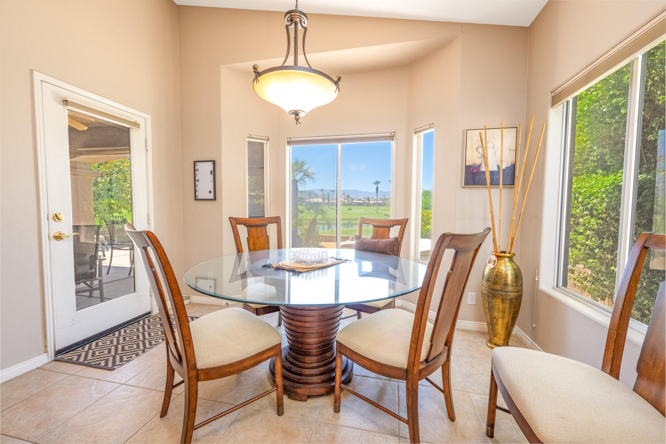 45233 Big Canyon Street Indio, CA 92201 - Photo 12 of 43 a dining room with furniture a chandelier and wooden floor