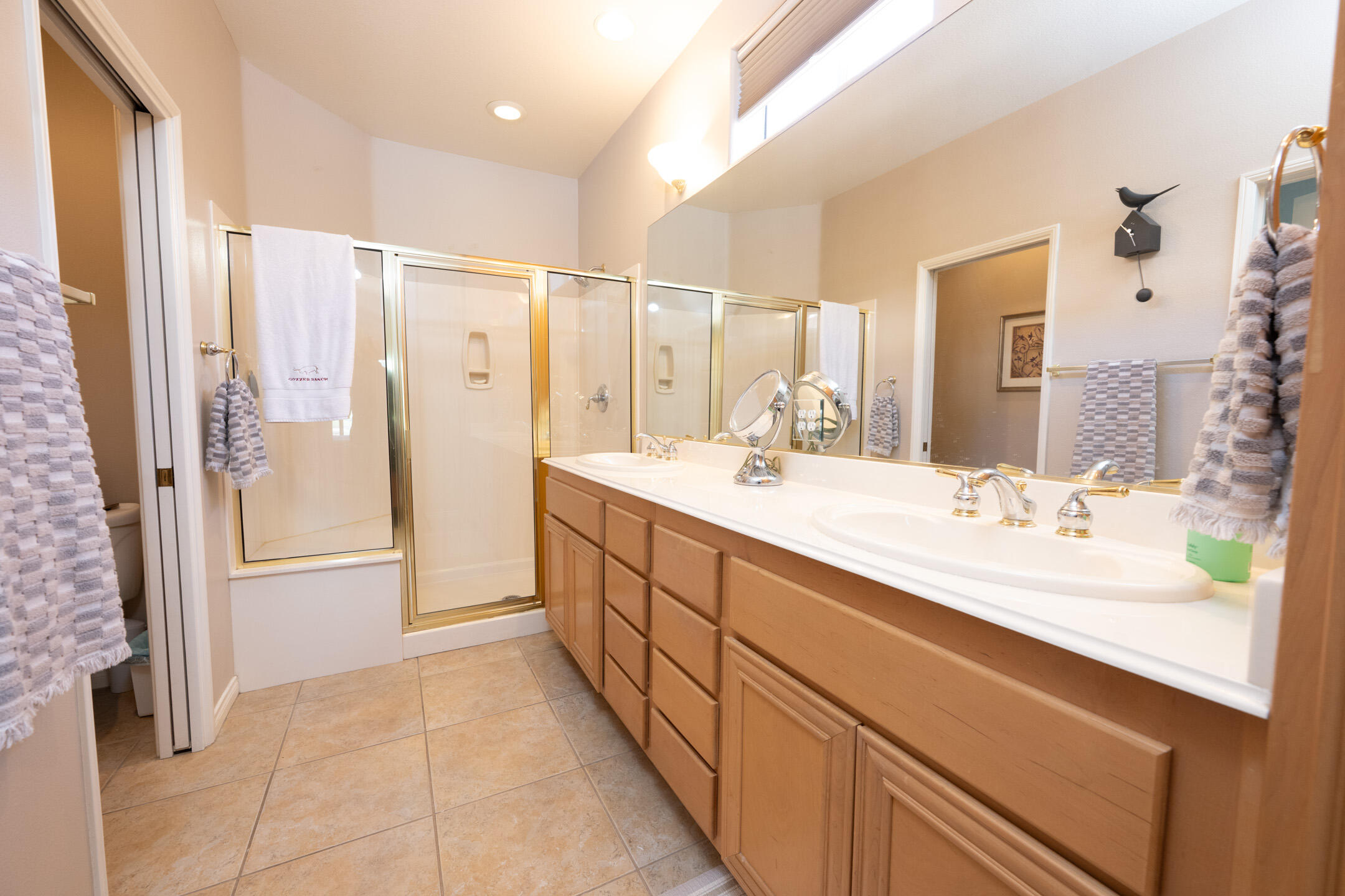 45233 Big Canyon Street Indio, CA 92201 - Photo 15 of 43 a bathroom with a double vanity sink a mirror a shower and a bathtub