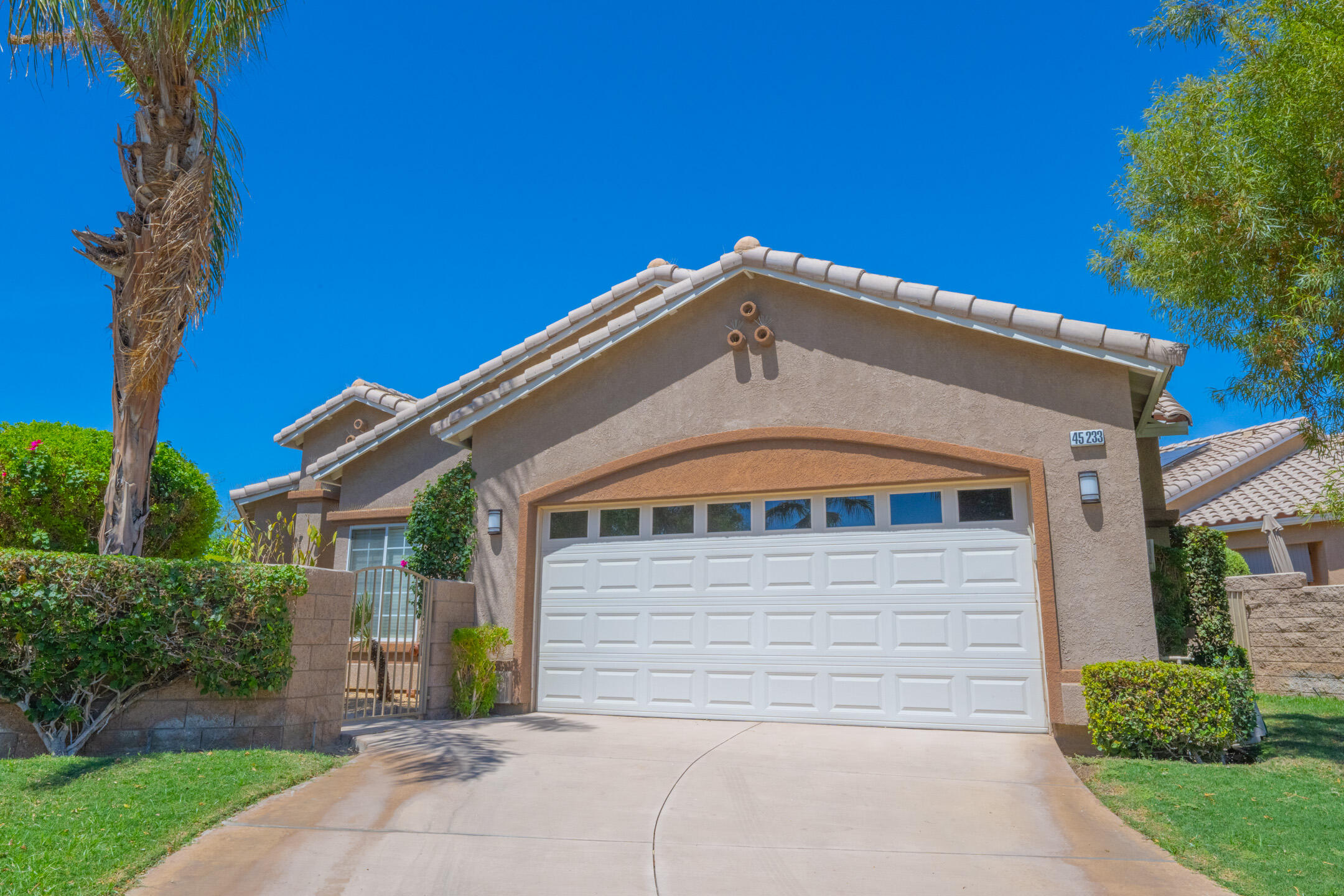 45233 Big Canyon Street Indio, CA 92201 - Photo 2 of 43 a front view of a house with a yard