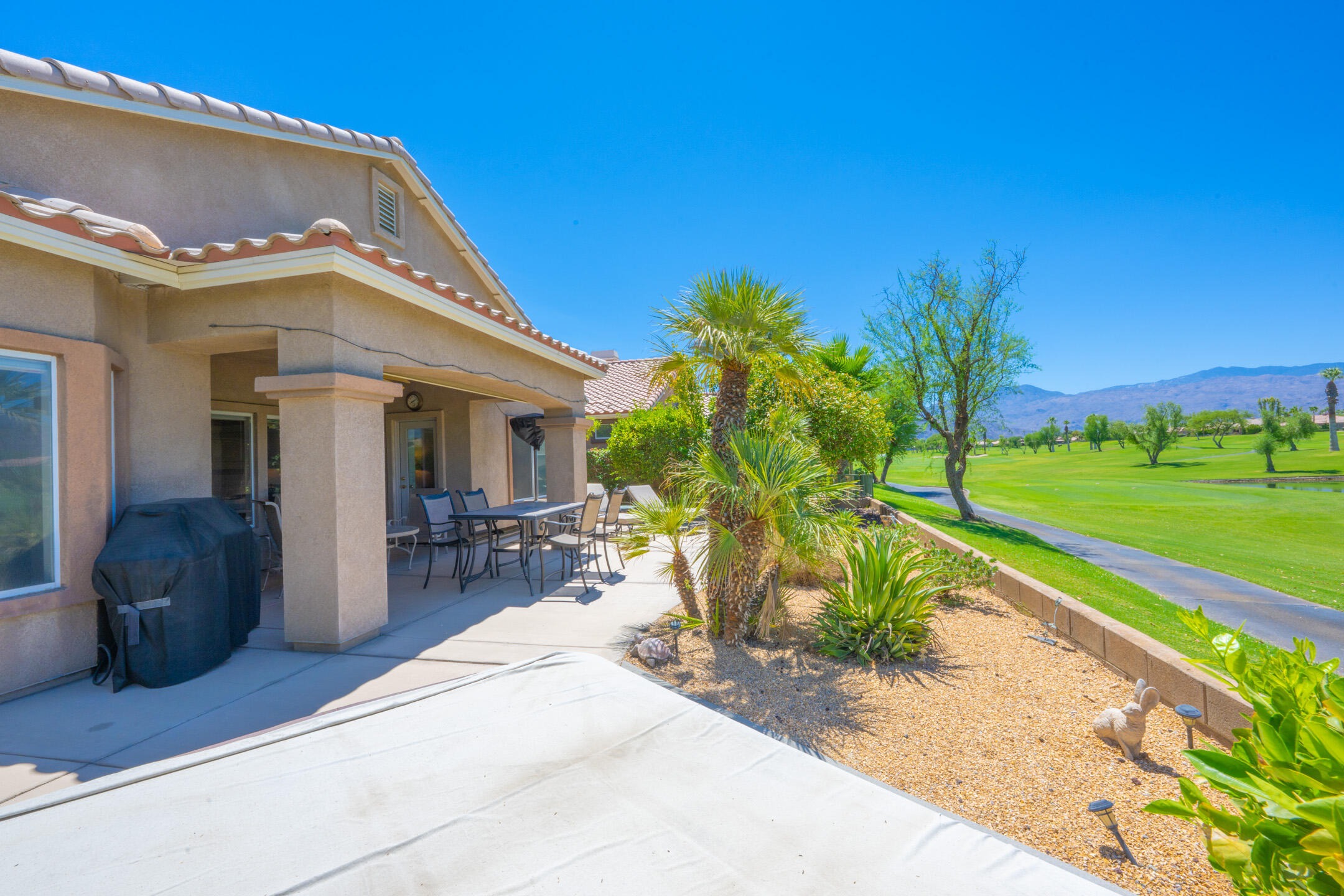 45233 Big Canyon Street Indio, CA 92201 - Photo 22 of 43 a view of a house with backyard porch and sitting area
