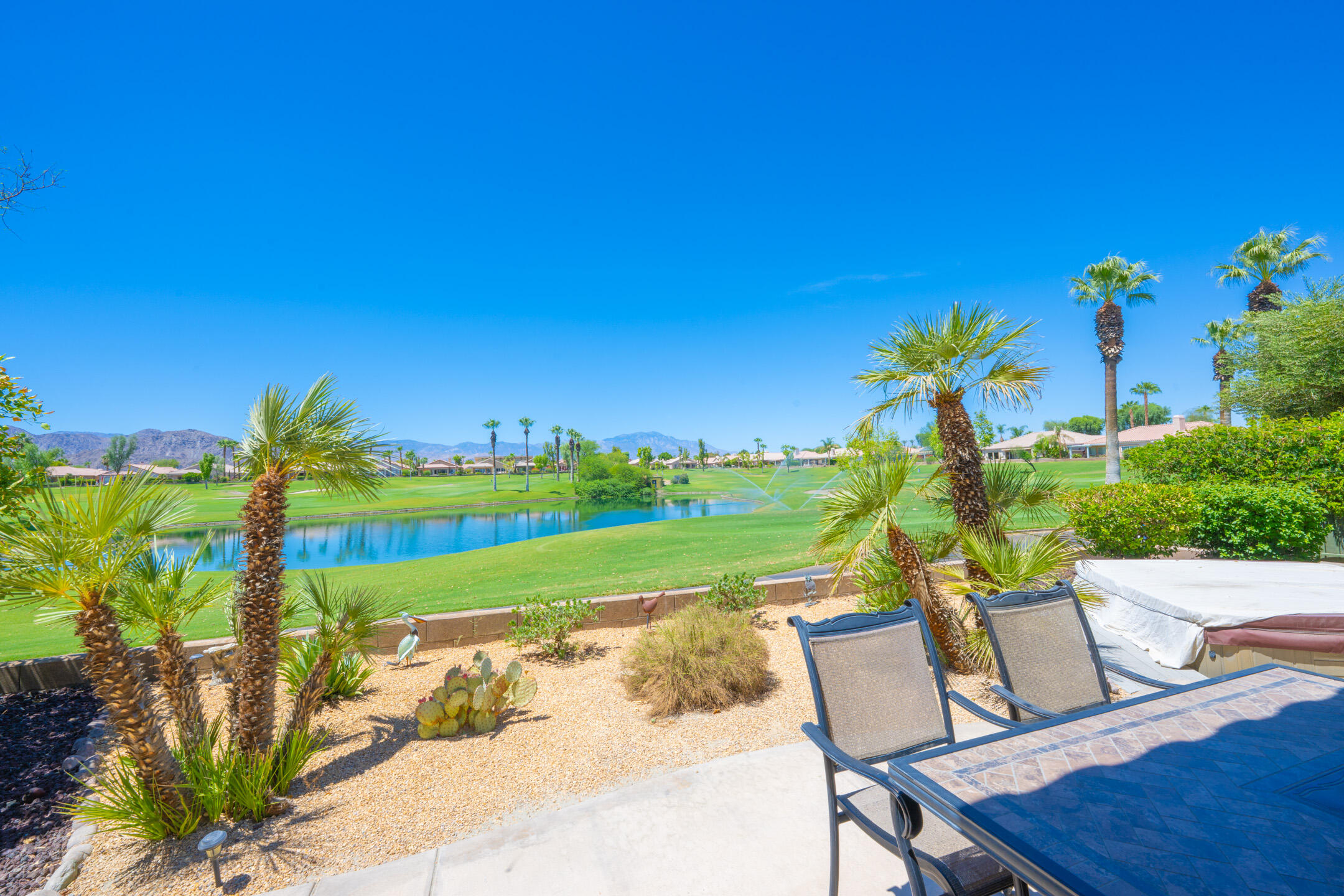 45233 Big Canyon Street Indio, CA 92201 - Photo 5 of 43 a view of a chairs and table in patio with a yard