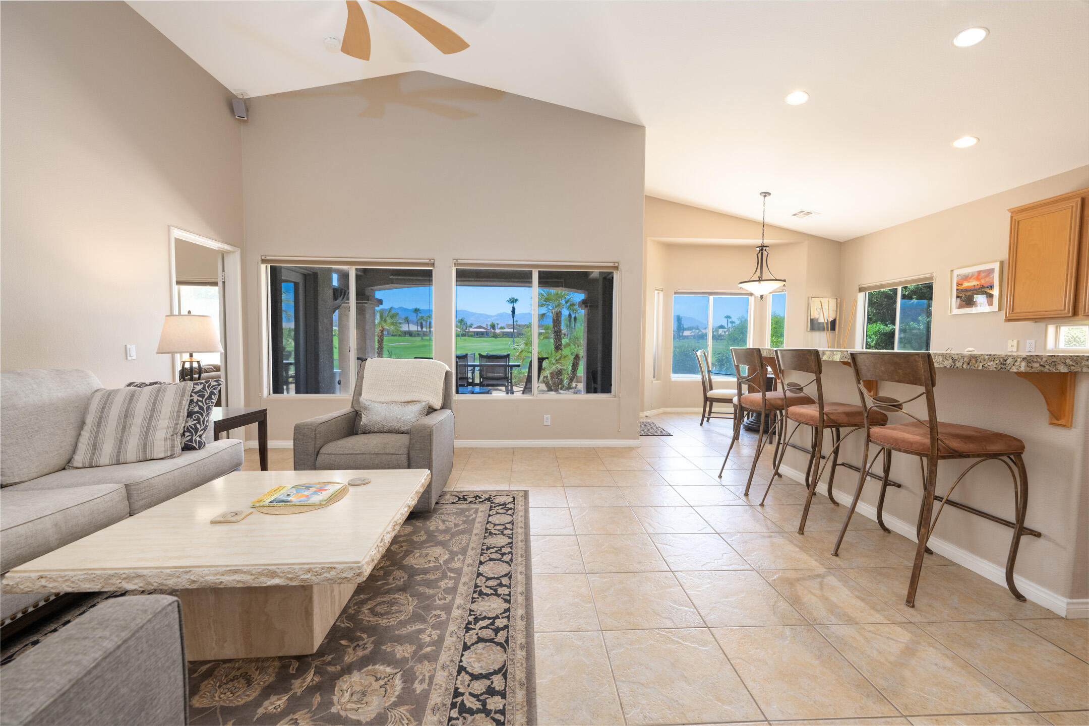 45233 Big Canyon Street Indio, CA 92201 - Photo 9 of 43 a living room with couches and a dining table with kitchen view