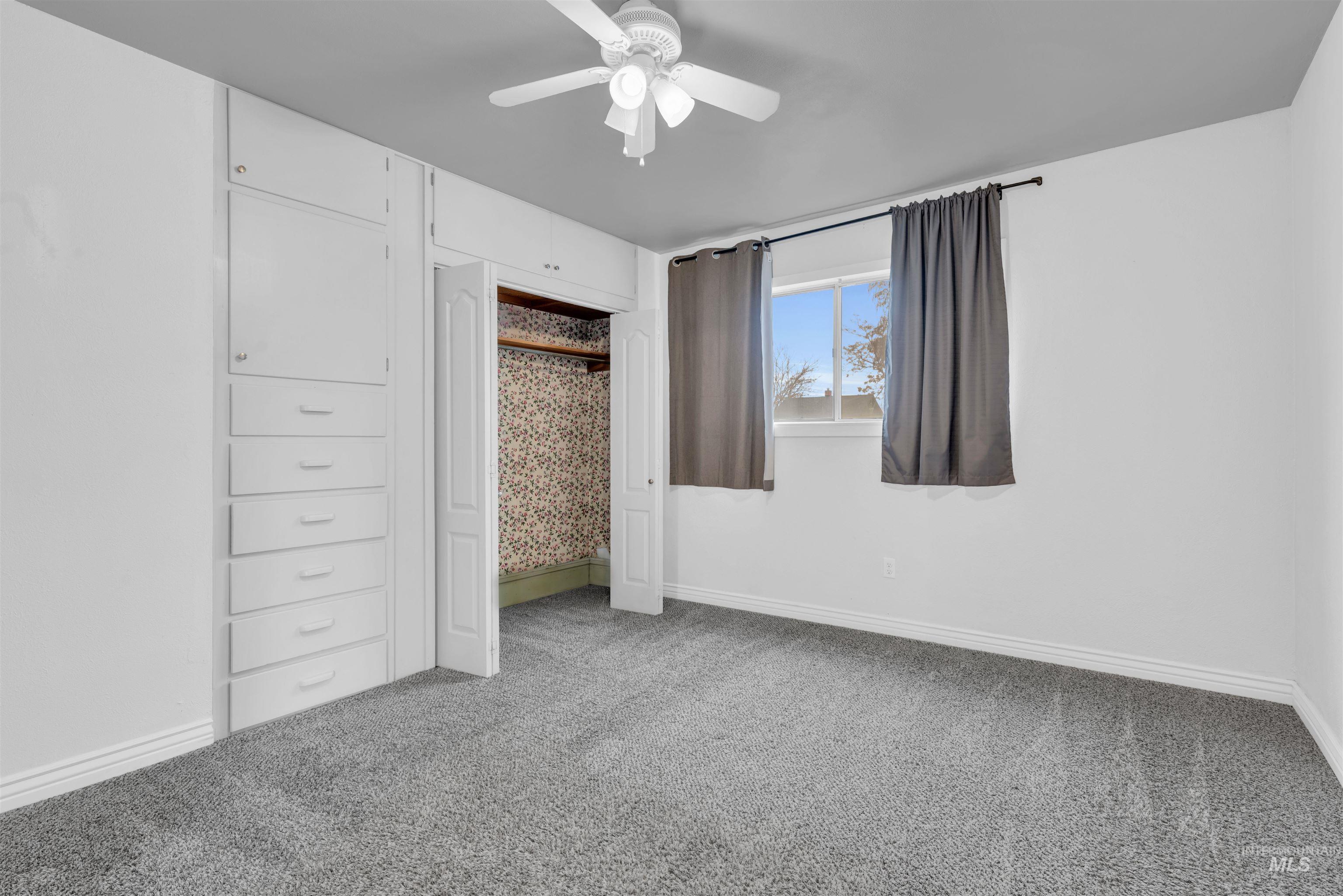 120 South Locust Street Nampa, ID 83686 - Photo 15 of 32 Unfurnished bedroom with ceiling fan, light colored carpet, and a closet