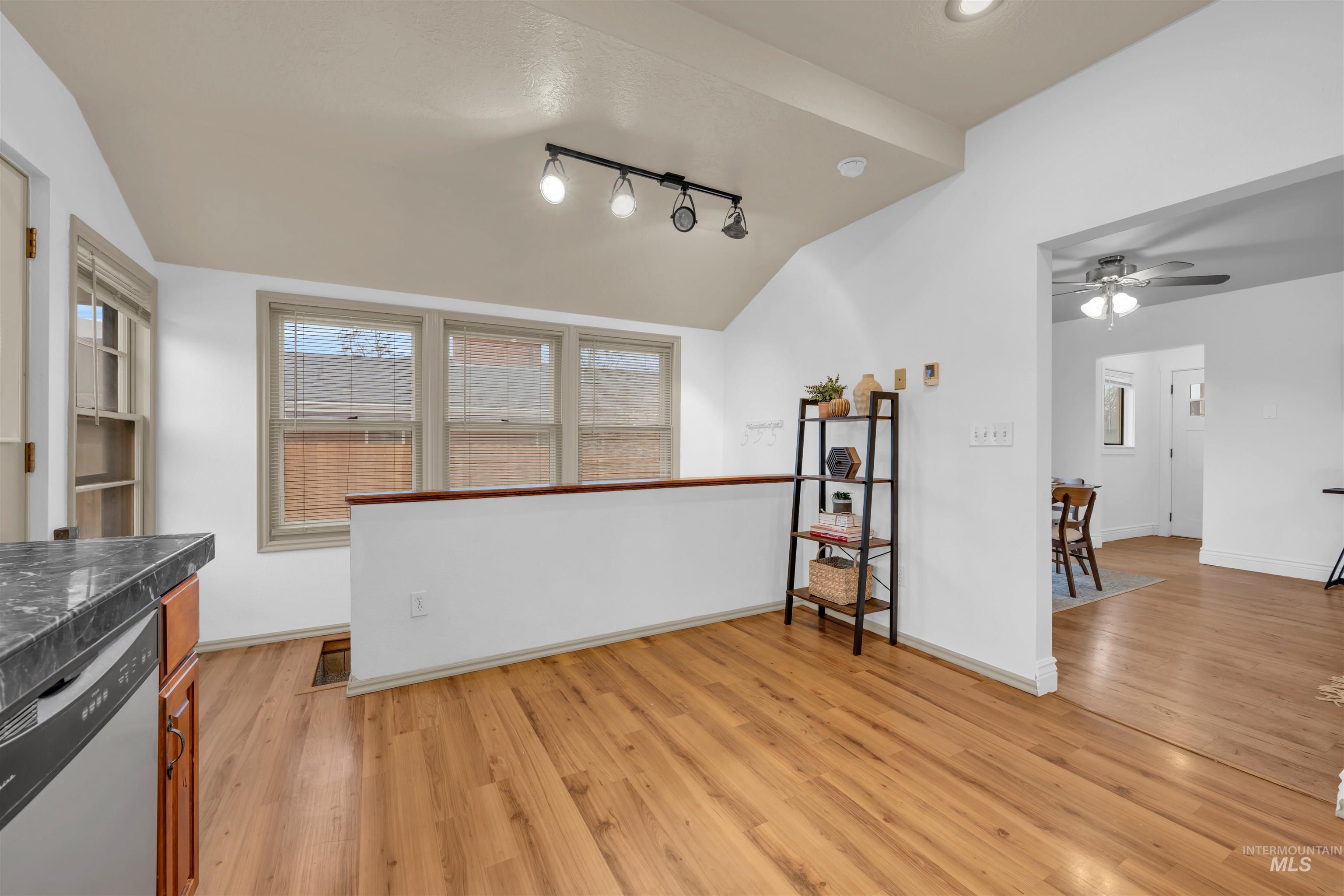120 South Locust Street Nampa, ID 83686 - Photo 18 of 32 Kitchen featuring dishwasher, lofted ceiling, dark countertops, light wood-type flooring, and a ceiling fan