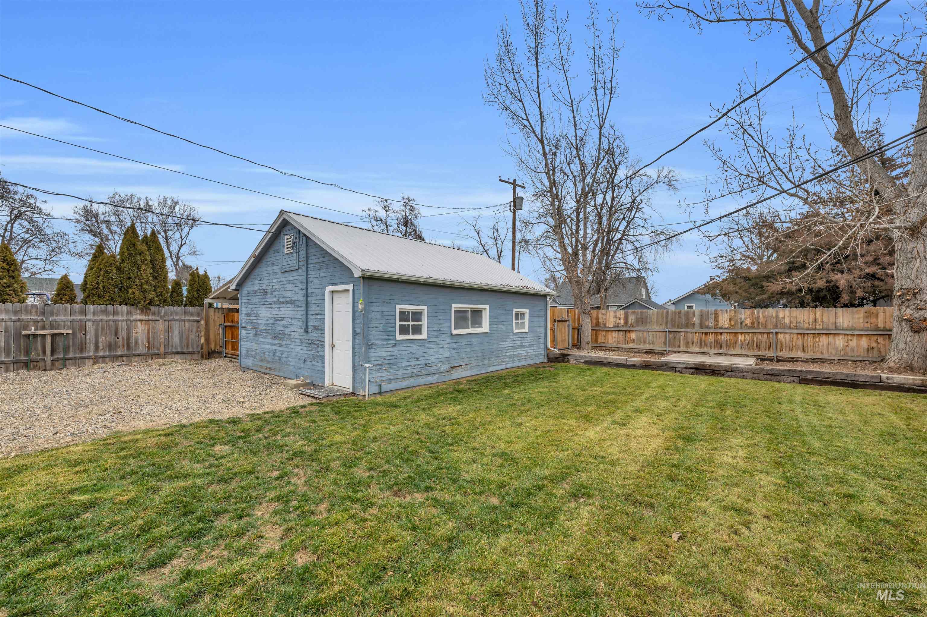 120 South Locust Street Nampa, ID 83686 - Photo 26 of 32 Fenced backyard featuring an outdoor structure