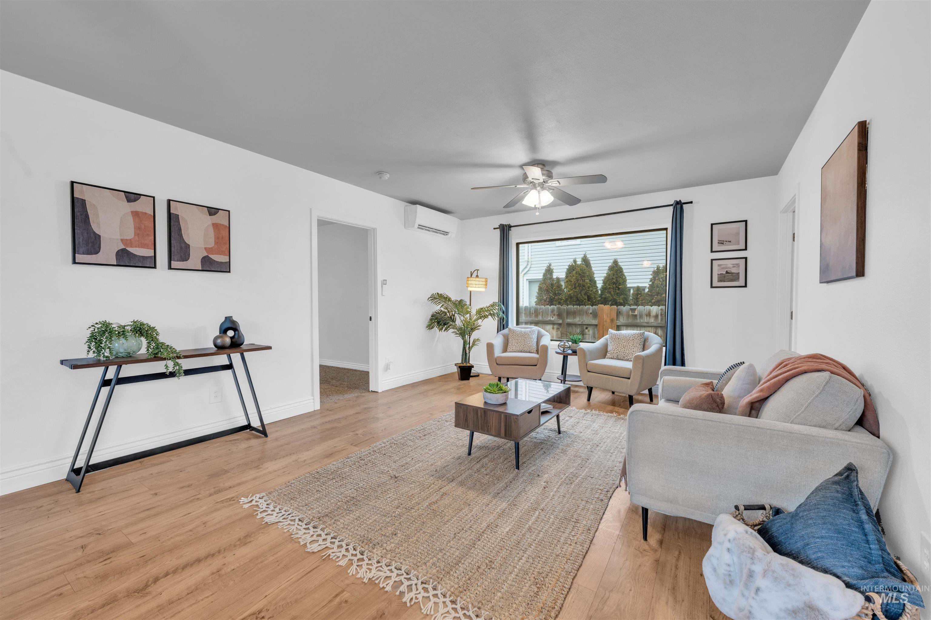 120 South Locust Street Nampa, ID 83686 - Photo 8 of 32 Living room featuring ceiling fan, light wood finished floors, and a wall mounted air conditioner