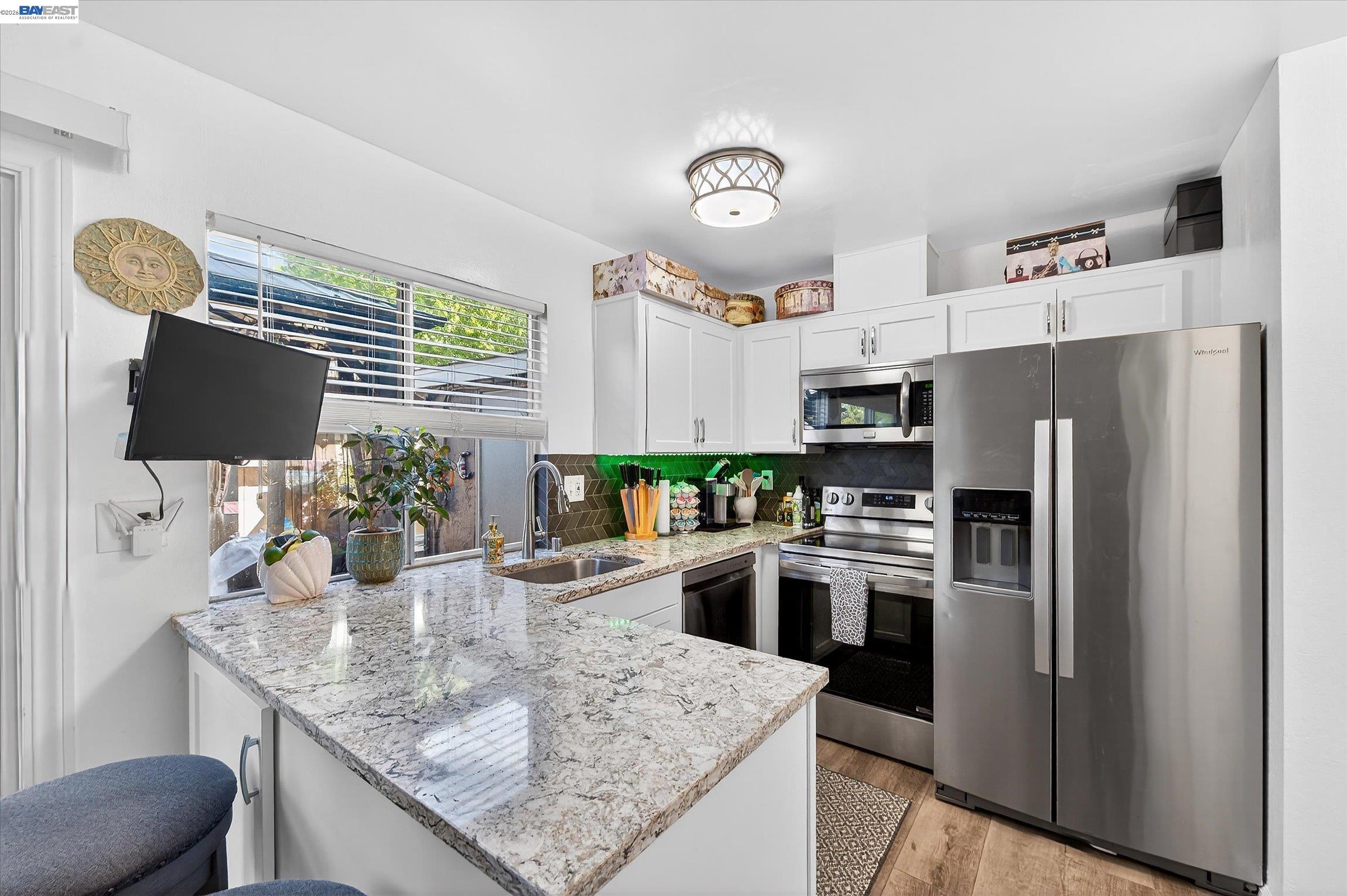 4416 Comanche Way Pleasanton, CA 94588 - Photo 11 of 24 a kitchen with stainless steel appliances granite countertop a refrigerator a stove top oven a sink and dishwasher