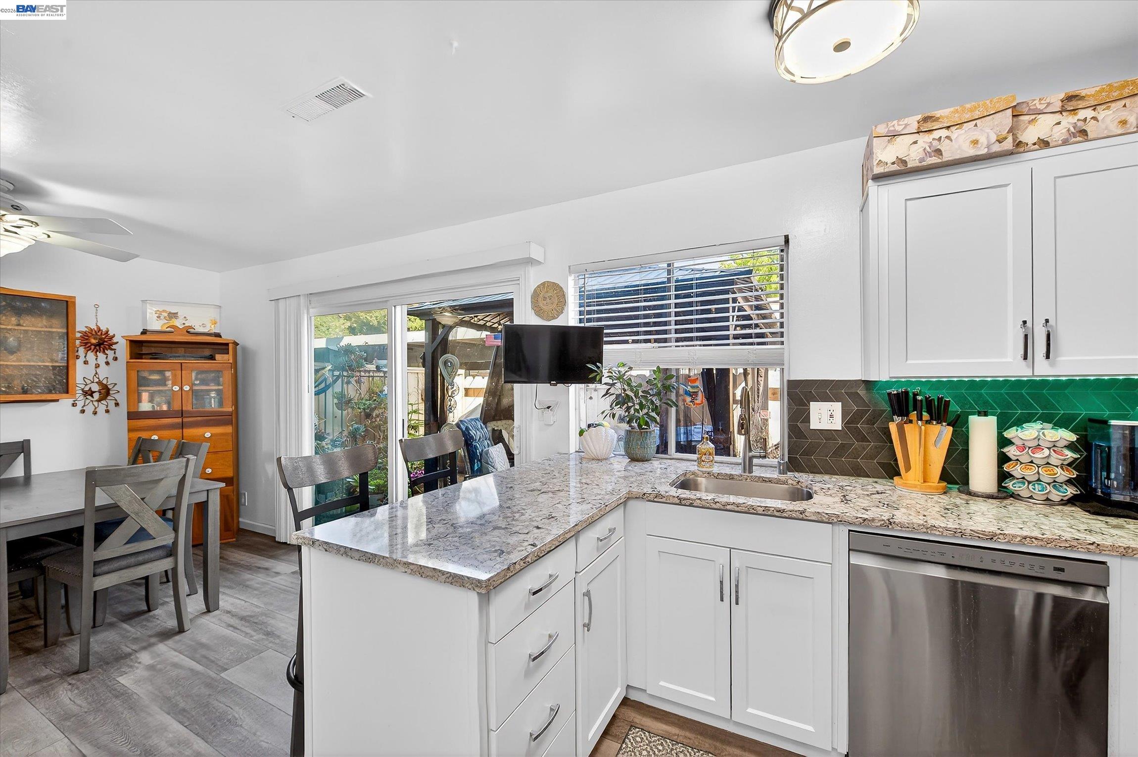 4416 Comanche Way Pleasanton, CA 94588 - Photo 13 of 24 a kitchen with granite countertop a sink and cabinets