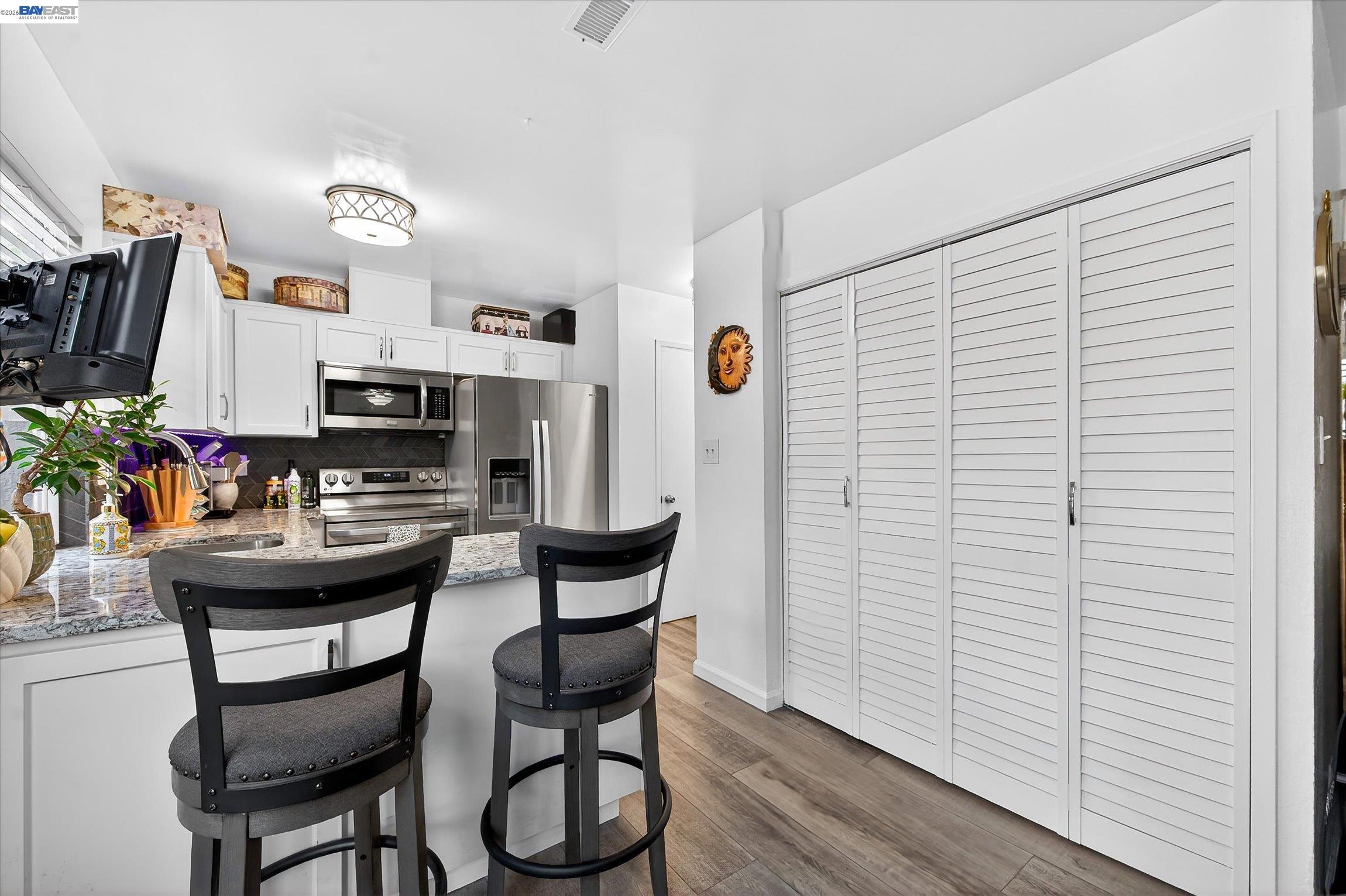 4416 Comanche Way Pleasanton, CA 94588 - Photo 9 of 24 a view of a dining room with furniture and wooden floor
