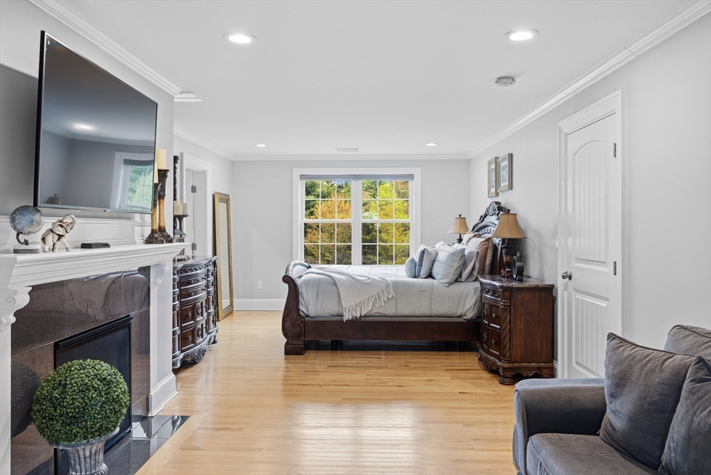 35 High Street Freetown, MA 02702 - Photo 33 of 40 a bed room with furniture and a fireplace