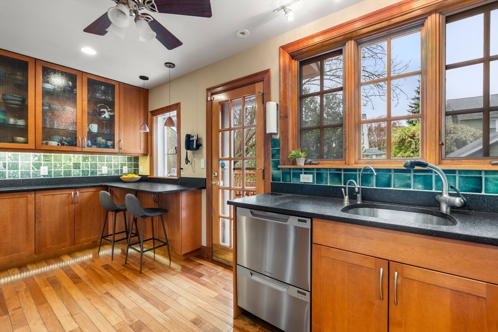 138 Albemarle Road Newton, MA 02460 - Photo 9 of 34 a kitchen with stainless steel appliances granite countertop sink stove and large window