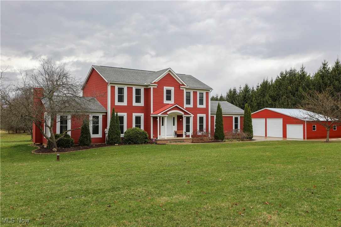 12565 Alpha Road Hiram, OH 44234 - Photo 2 of 50 Colonial house featuring a garage, an outdoor structure, a front yard, and a shingled roof