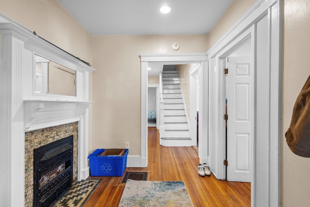 7 Simpson Avenue Somerville, MA 02144 - Photo 11 of 36 a bedroom with furniture and a fireplace