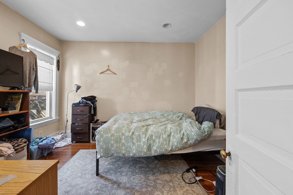 7 Simpson Avenue Somerville, MA 02144 - Photo 12 of 36 a bedroom with furniture and a flat screen tv