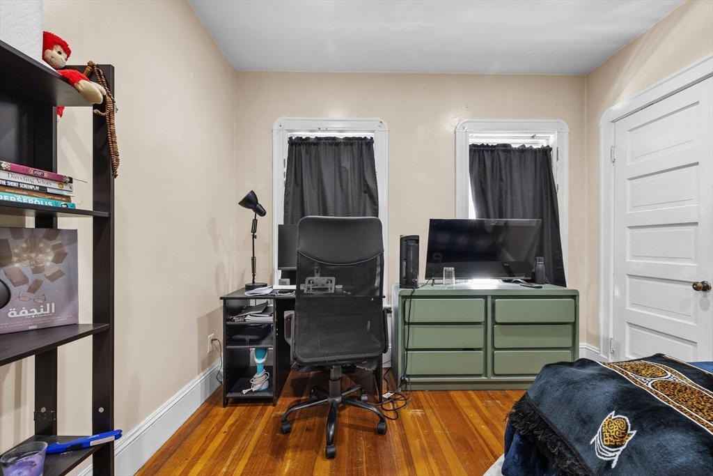 7 Simpson Avenue Somerville, MA 02144 - Photo 16 of 36 a workspace with furniture and wooden floor