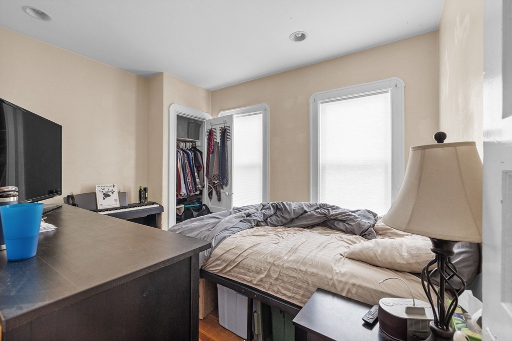 7 Simpson Avenue Somerville, MA 02144 - Photo 17 of 36 a bedroom with a bed and a flat screen tv