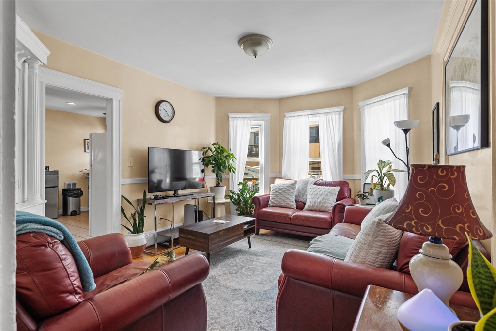7 Simpson Avenue Somerville, MA 02144 - Photo 2 of 36 a living room with furniture a large window and a flat screen tv