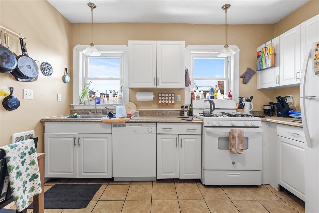 7 Simpson Avenue Somerville, MA 02144 - Photo 23 of 36 a kitchen with a sink window and cabinets