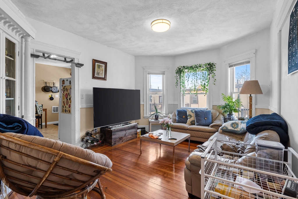 7 Simpson Avenue Somerville, MA 02144 - Photo 24 of 36 a living room with furniture and a flat screen tv