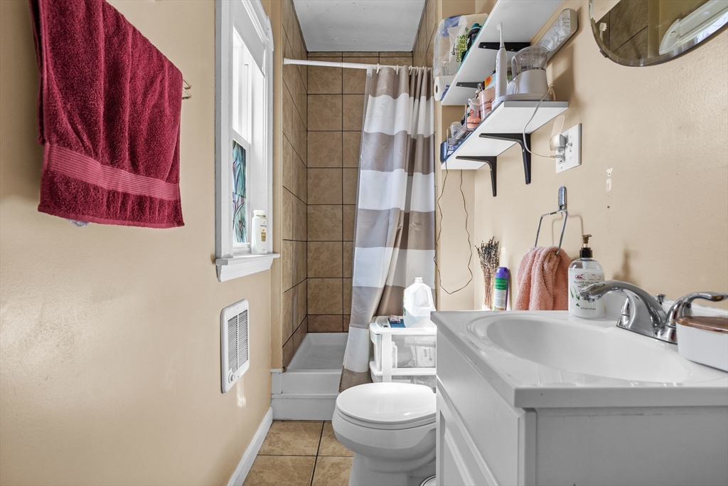 7 Simpson Avenue Somerville, MA 02144 - Photo 28 of 36 a bathroom with a sink a toilet and a mirror