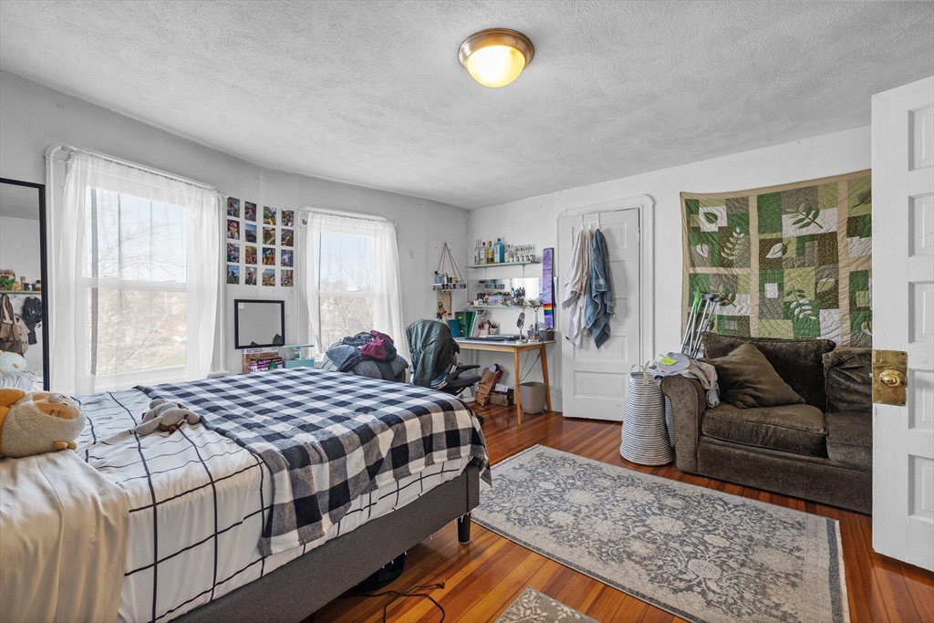 7 Simpson Avenue Somerville, MA 02144 - Photo 30 of 36 a bedroom with a bed couch and a large window