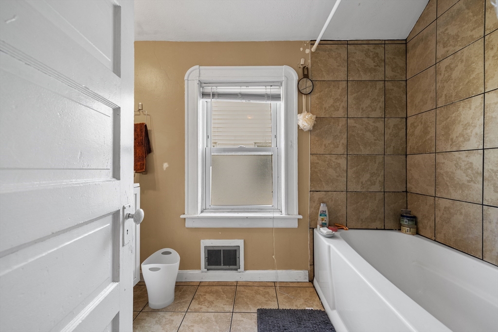 7 Simpson Avenue Somerville, MA 02144 - Photo 32 of 36 a bathroom with a toilet and bathtub