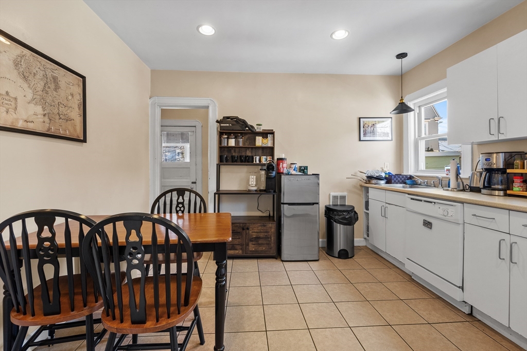 7 Simpson Avenue Somerville, MA 02144 - Photo 5 of 36 a kitchen with a refrigerator and microwave