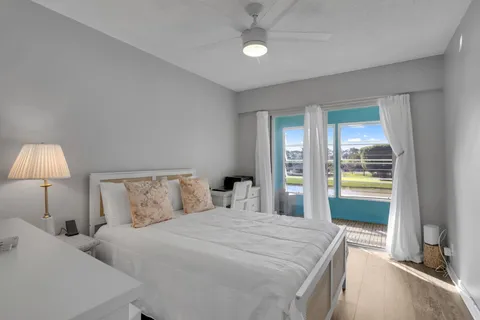 a bedroom with a bed and a large window