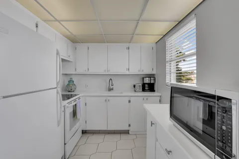 a kitchen with cabinets appliances and a window